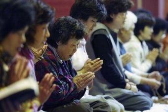 South Korea women pray for their children's success in the annual college entrance examination. Photo by Chung Sung-Jun/Thinkstock.